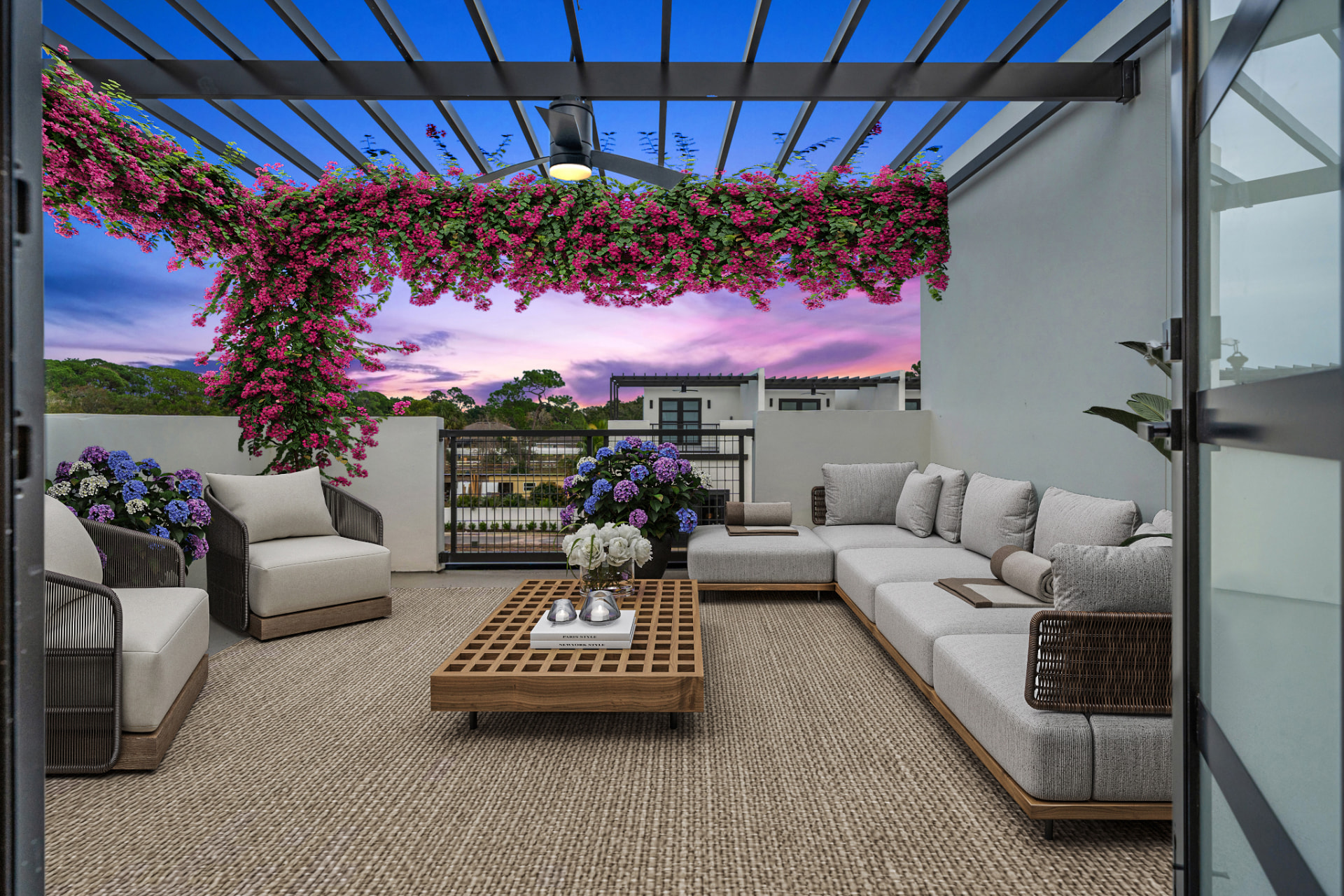 Private rooftop terrace at dusk with a steel pergola, bougainvillea in bloom and lounge seating at Latitudes in the Park, Pinellas Park FL